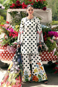 Woman in white polka dot floral print palazzo suit with matching dupatta, standing by a flower-decked vintage car.
