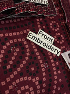 Front embroidery on maroon fabric with geometric patterns and sequin accents