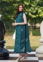 Teal embroidered lawn dress with lace detailing, styled with silver heels on giant chessboard