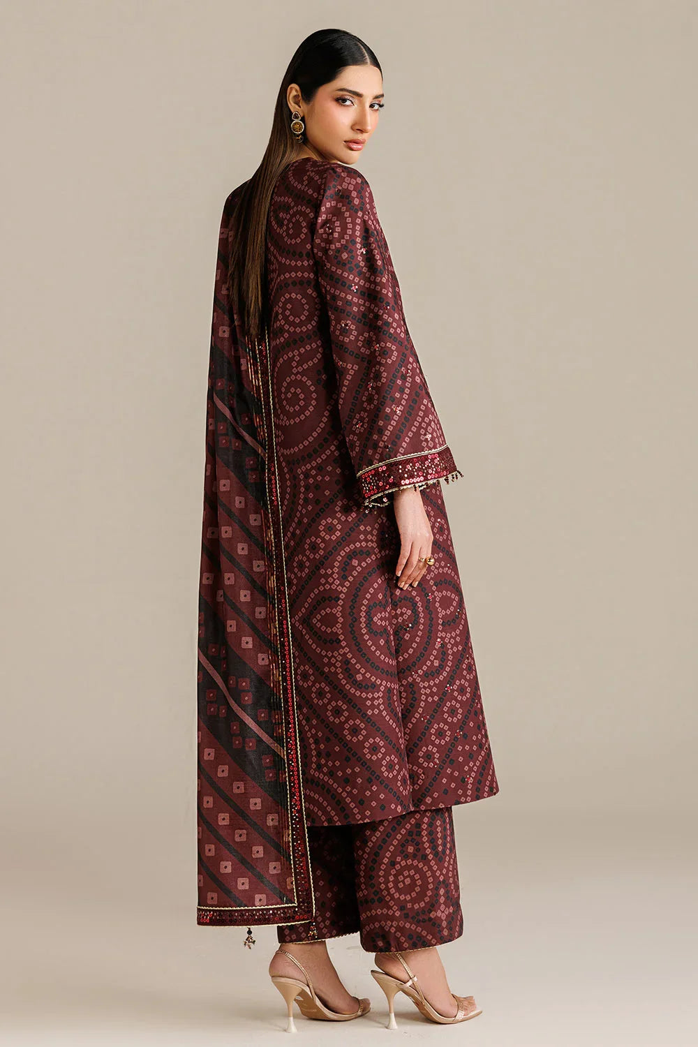 Elegant maroon printed kurta set with intricate patterns and embellished sleeves