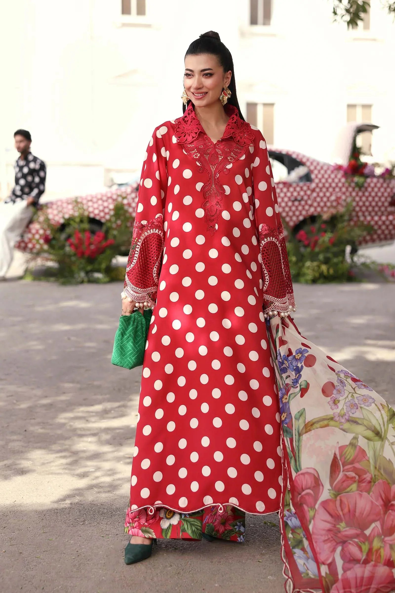 Red polka dot dress with floral dupatta and lace detailing, styled with green accessories