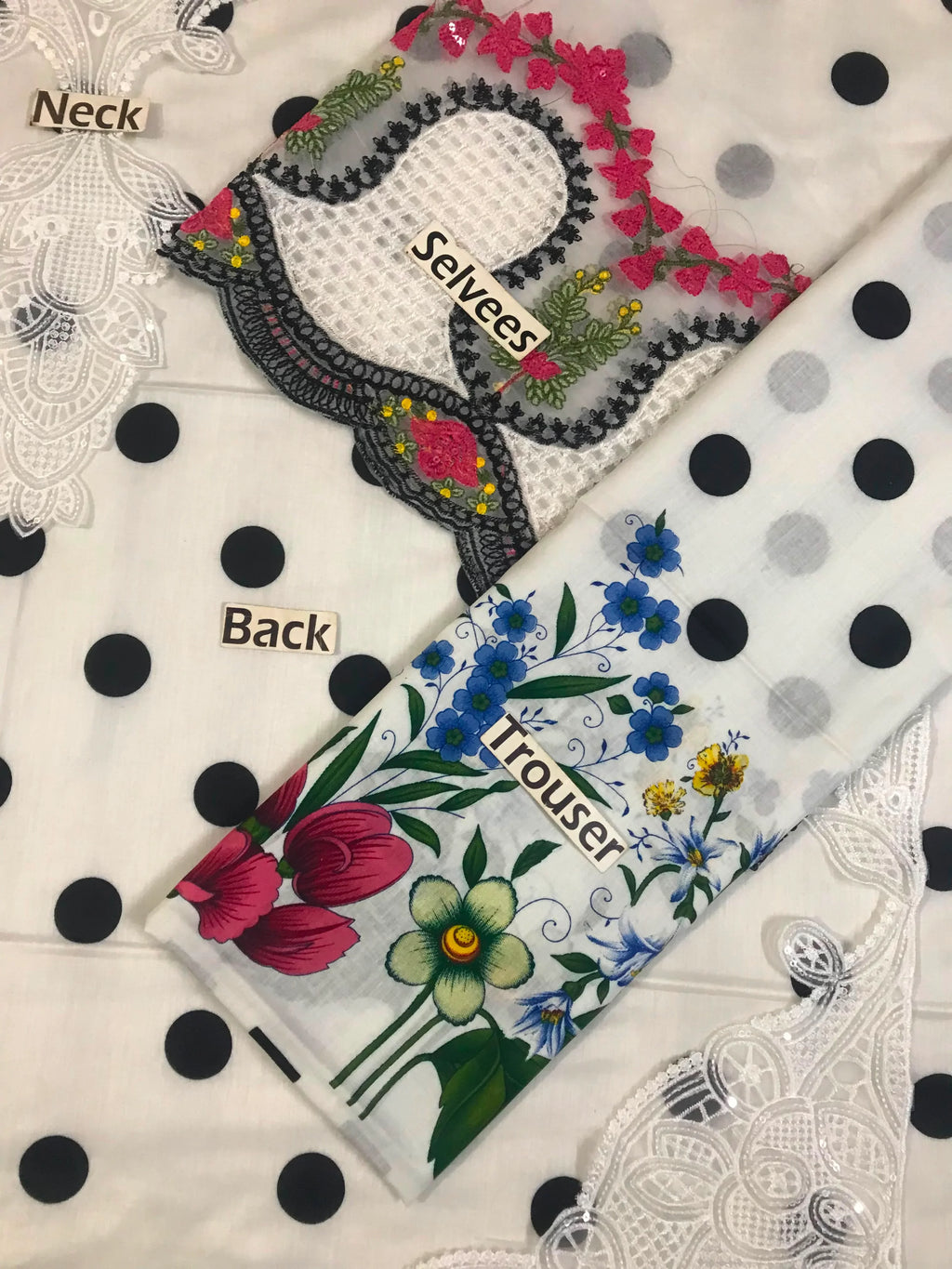 Floral embroidered blouse with lace sleeves and polka dot trousers