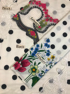 Floral embroidered blouse with lace sleeves and polka dot trousers
