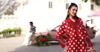 Red polka dot dress with lace detailing, elegant outdoor fashion