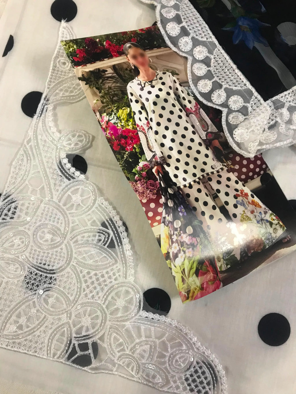 Elegant white lace trim with intricate floral embroidery and sequin details, perfect for dressmaking and fashion design projects.