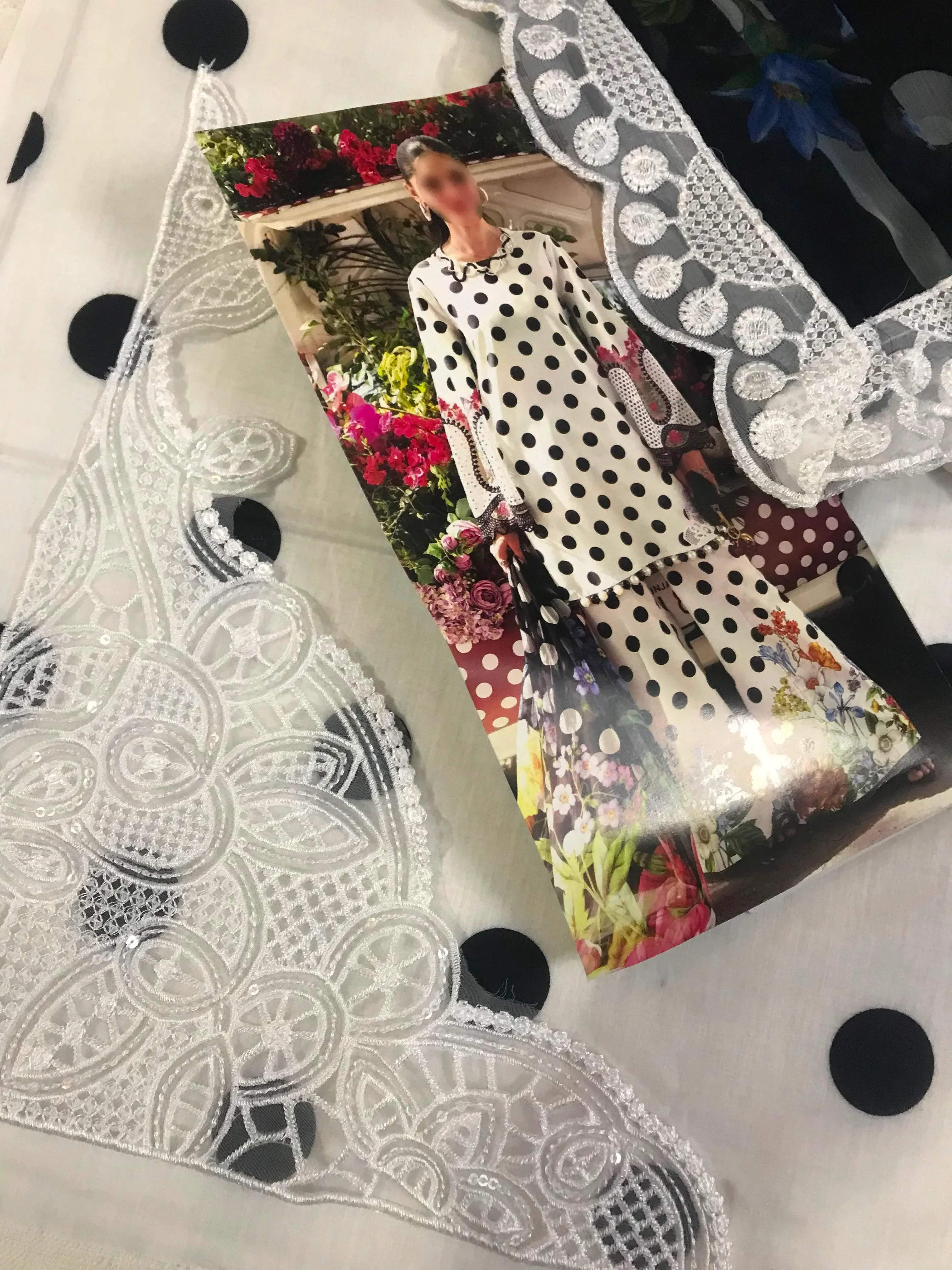 Elegant white lace trim with intricate floral embroidery and sequin details, perfect for dressmaking and fashion design projects.