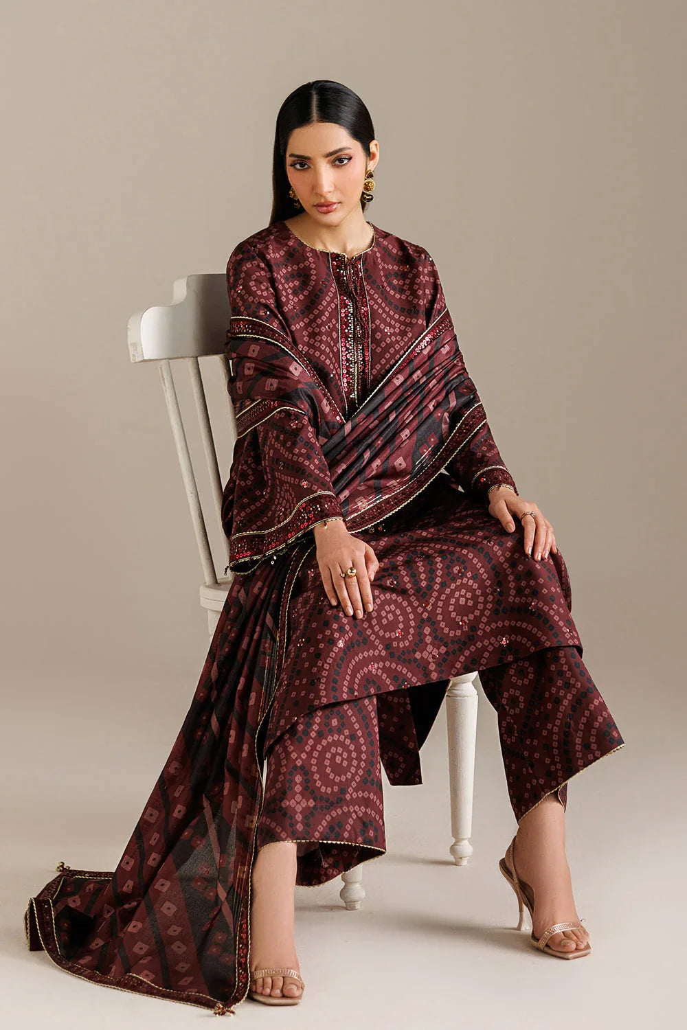 Elegant maroon printed kurta set with geometric patterns and gold detailing, paired with matching palazzo pants.